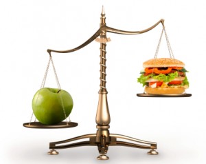 Apple and hamburger on scales conceptual